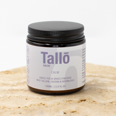 Jar of Tallo skin cream on a light background