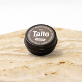 Tallo lip balm container on a marble surface