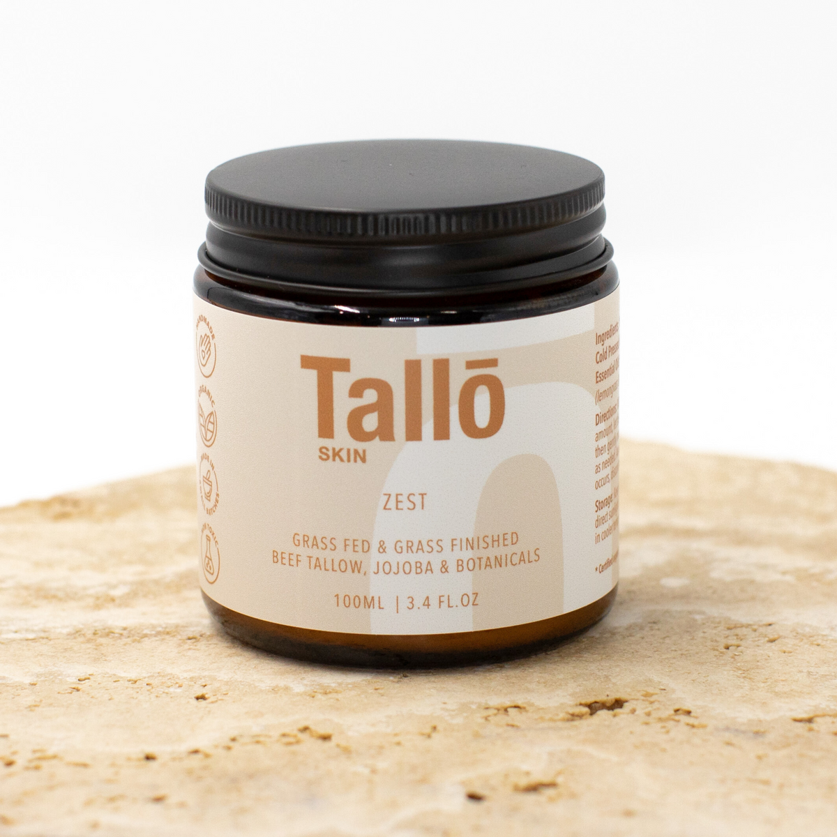 Jar of Talló Skin Zest on a light brown surface with a white background