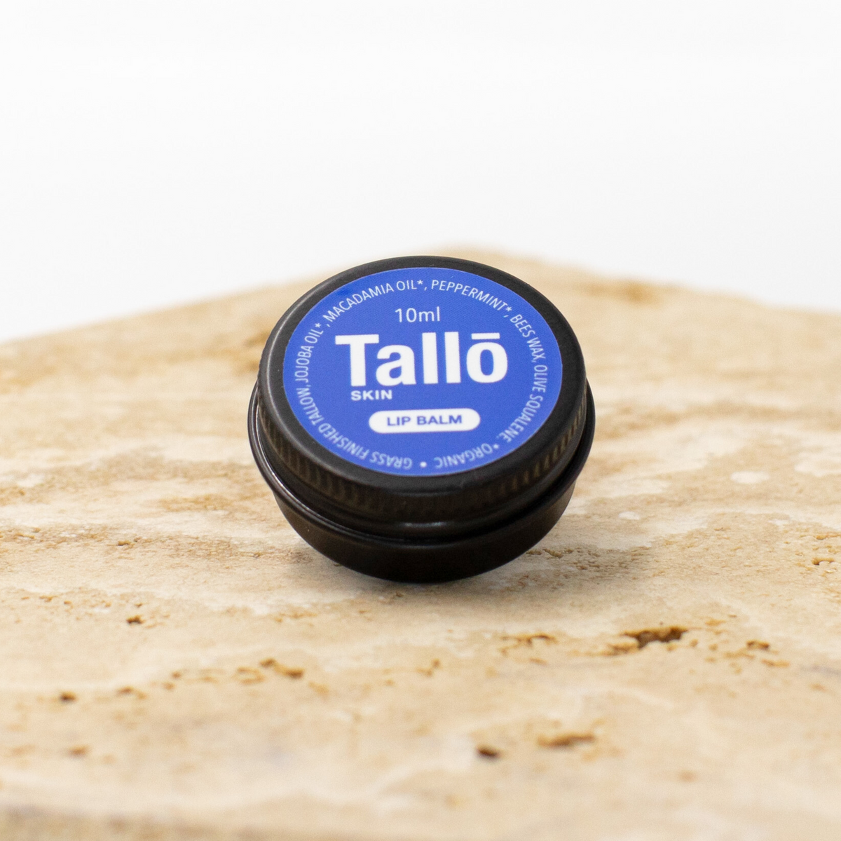 Tallo lip balm container on a wooden surface