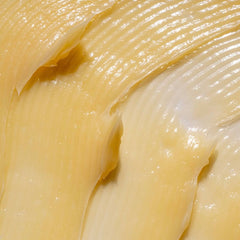 Close-up of a smooth, orange-colored cream or paste