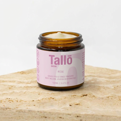 Jar of Tailo skin cream on a wooden surface with a white background